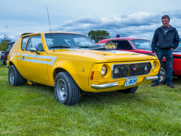 Truro, Nova Scotia, Canada - June 5, 2010 : American Motors Corporation Gremlin X at local car show in Truro, Nova Scotia, Canada. A man stands near to the car.