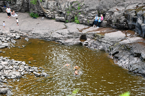 Two Harbors, MN/USA - August 2, 2020. People enjoying the opportunity to swim in the low water level pools of Gooseberry Falls, a very popular state park destination.