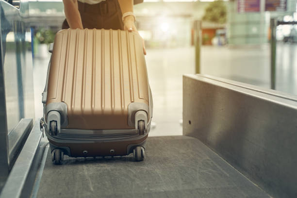istock Focused photo on female hand holding suitcase 1264170743