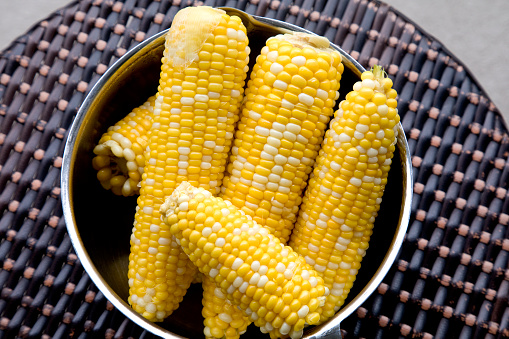 Homemade boiled corn on cob in a bowl, ready to eat