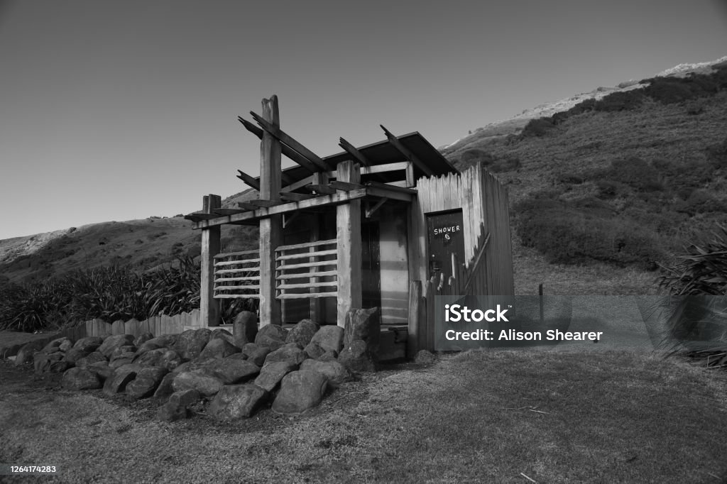 A kiwi restroom A black and white of a wooden rest room in the country side of New Zealand. Architecture Stock Photo