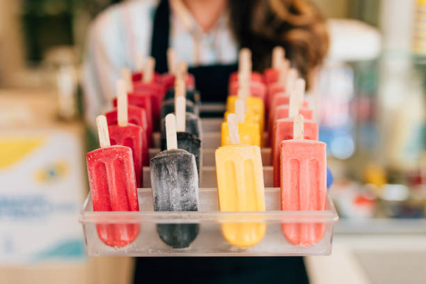 istock Happy brunette worker in ice cream store 1264177009