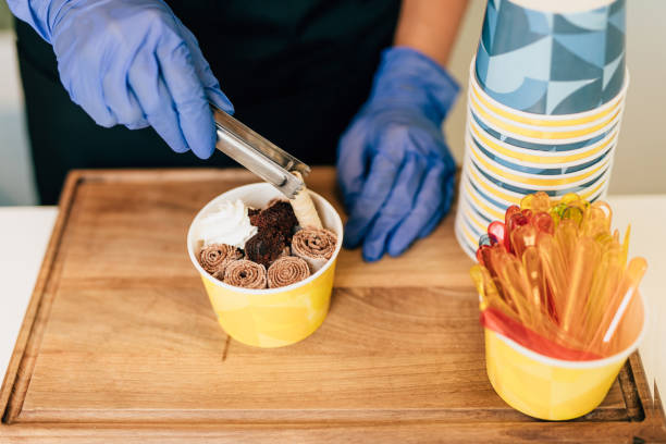 istock Happy brunette worker in ice cream store 1264177013