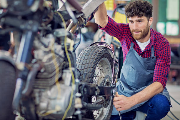 istock Man is working on a custom made motorbike 1264177604