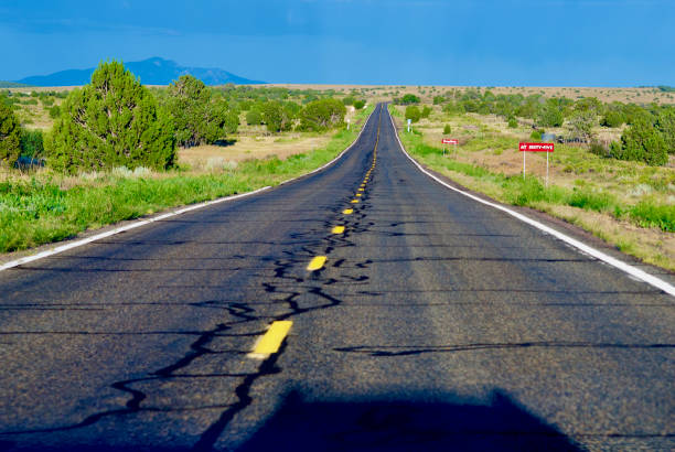 Two Roads crossing in the Agricultural area of  Blythe California. Located in the Palo Verde Valley of the lower Colorado River Valley .  Mountains in the background. Very green and well irrigated considering this is a desert area.