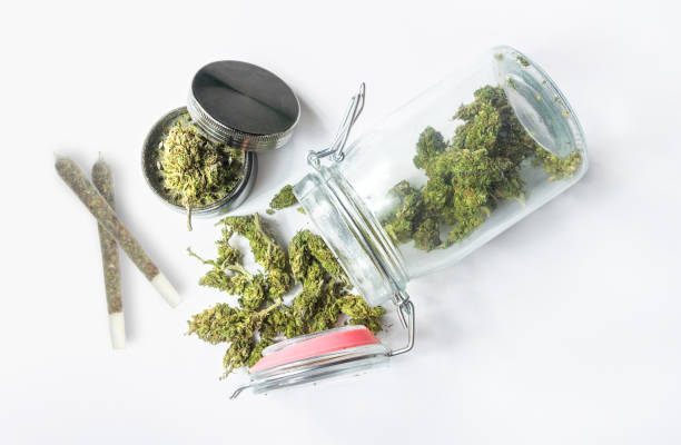 Medical Marijuana in a mason jar buds Joint and grinder on isolated on white Medical Marijuana in a mason jar buds Joint and grinder on isolated on white, Medical Cannabis concept blunts stock pictures, royalty-free photos & images