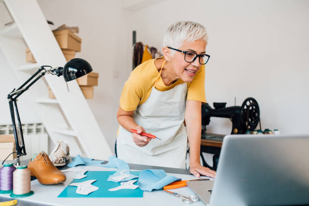 istock Mature woman working at her shoe workshop 1264181437