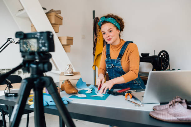 istock Young female shoemaker filming a video blog 1264181491