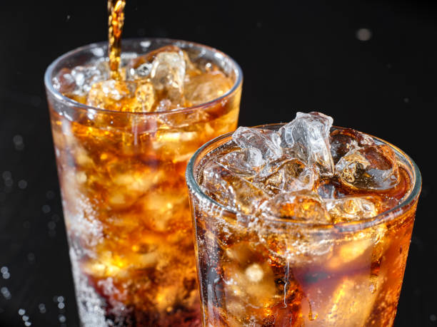istock two cups of cola soft drink being poured into glass 1264183482