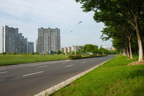 istock Clear sky, urban buildings, roads by dense woods 1264195083