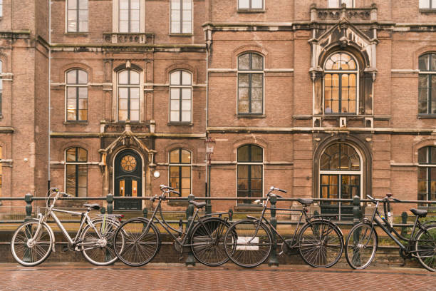 istock beautiful bicycle with old tradition building house brown brick amsterdam netherlands 1264197062