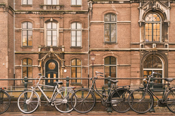 istock beautiful bicycle with old tradition building house brown brick amsterdam netherlands 1264197073