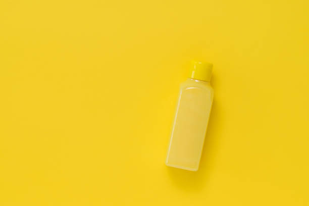 istock A yellow plastic bottle with a yellow liquid on a yellow background. 1264200715