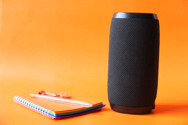 istock smart speaker and keyboard with copy space on orange background background 1264202609
