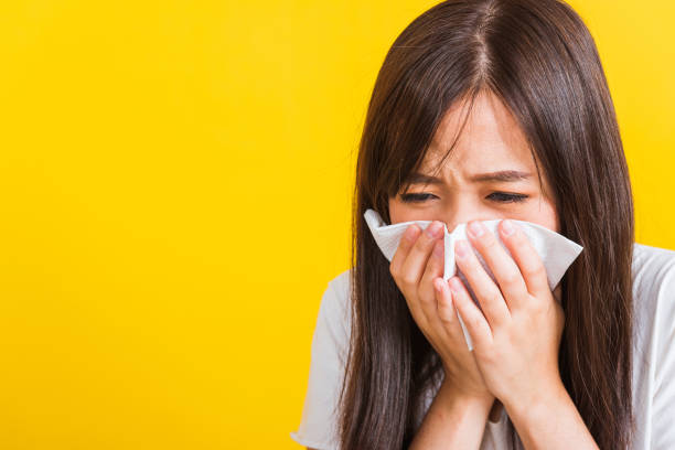 istock Woman sneezing sinus using towel to wipe snot from nose 1264202853