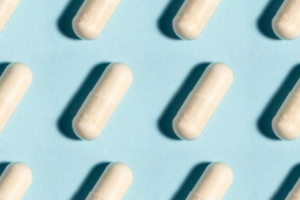 istock Seamless medical pill, pharmaceutical medicine capsule pattern. Painkiller, vitamin, antibiotic, probiotic on blue background. 1264205379