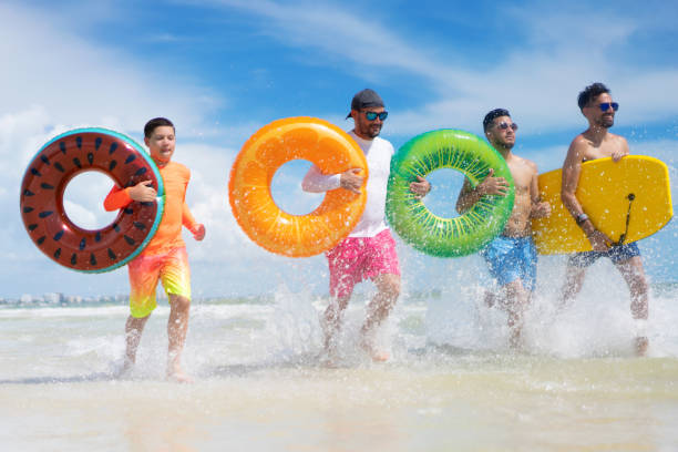 istock Running with inflatable tubes on a beach in Florida 1264207182