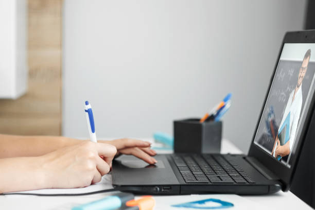 istock Beautiful girl using laptop studying at home, online education concept, studying science behind a laptop. Watching a webinar, looking for friends on social networks. Modern technologies. 1264210008