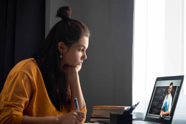 istock Beautiful girl using laptop studying at home, online education concept, studying science behind a laptop. Watching a webinar, looking for friends on social networks. Modern technologies. 1264210010