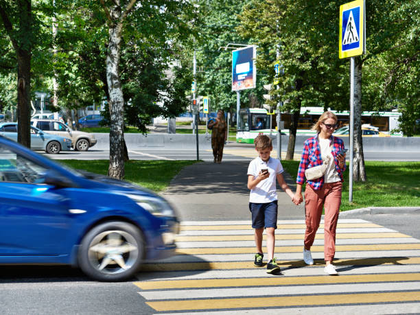 istock Danger of using smartphone by pedestrians on road 1264211852
