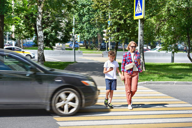istock Danger of using smartphone by pedestrians on road 1264211890