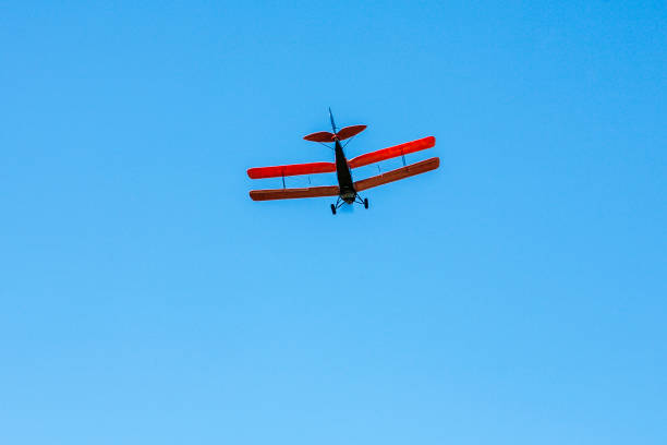 istock Tiger moth plane flying on the blue sky 1264215377