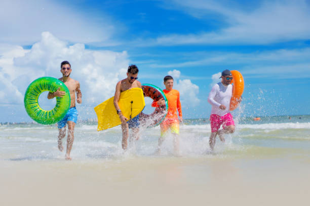 istock Running with inflatable ring tubes having fun in Florida 1264215498