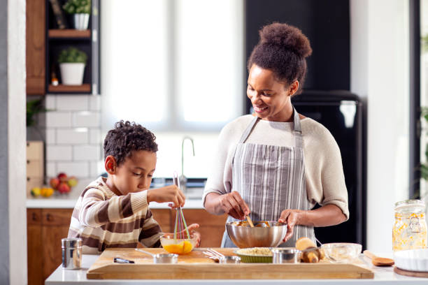 istock Mother with his son prepare pie in the kitchen 1264216155
