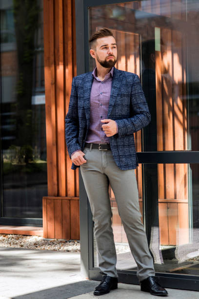 istock Man in gray jeans and a jacket posing 1264217149