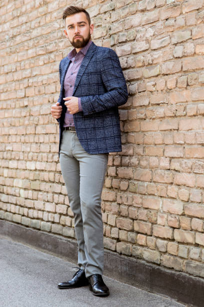 istock Man in gray jeans and a jacket posing 1264217186