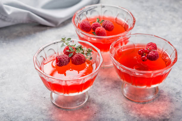 istock Raspberry jelly garnished with fresh raspberries and thyme on a light background. 1264217200