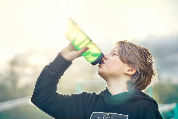 istock Active kid drinking fresh water on street 1264218817