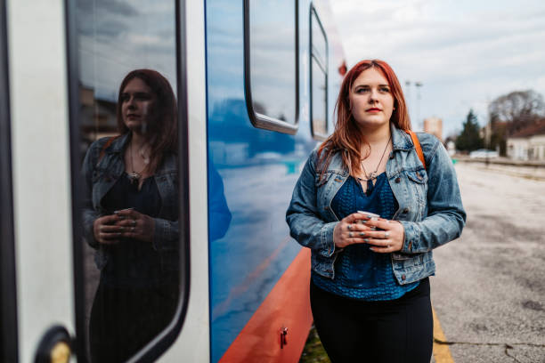 istock Young woman on train station 1264218836