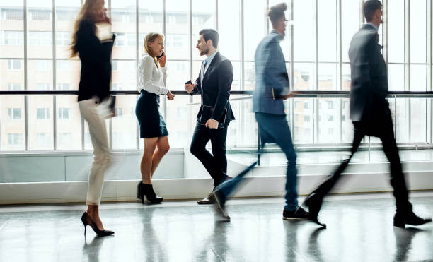 istock Business people walking along the corridor 1264223256