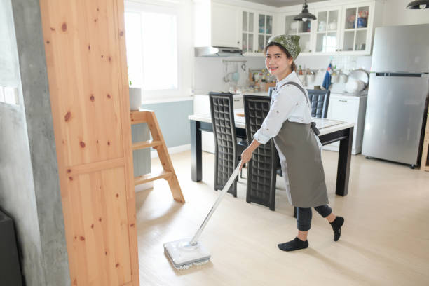 istock A young maid cleaning the house with a mop There is a kitchen backdrop 1264225048