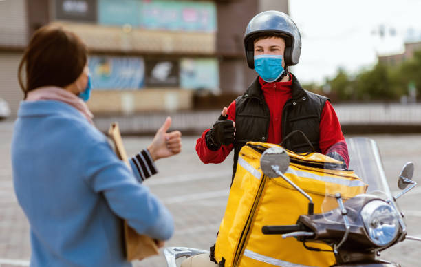 istock Cheerful Courier And Customer Girl Gesturing Thumbs Up Standing Outside 1264225527