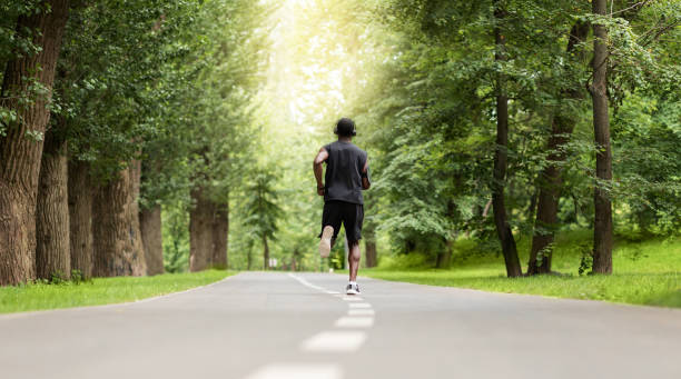 istock Rear view of black jogger exercising at park 1264226803