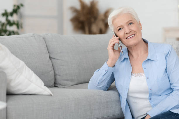 istock Concierge Services. Smiling Senior Woman Talking On Cellphone With Personal Assistant Manager 1264228001