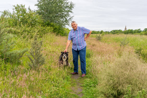 istock Man on grassland with border collie 1264230531