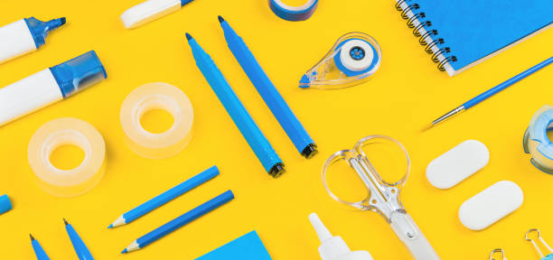 istock Assorted office and school white and blue stationery on yellow 1264231859