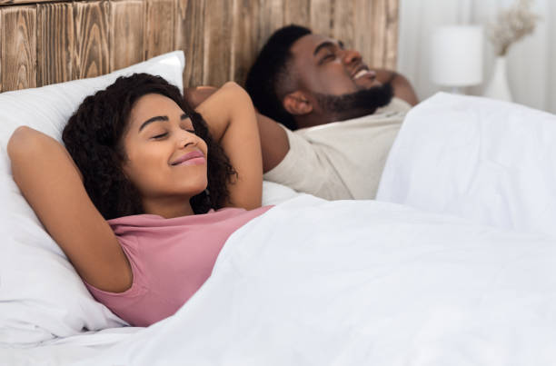 istock Relaxed african couple enjoying their new bed 1264232046