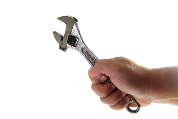 istock hand of man holding wrenches isolated on white background. 1264232121