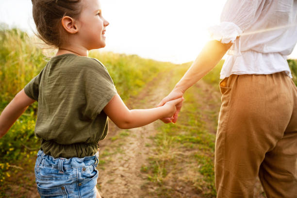 istock Mom taking her little daughter gently by the hand 1264239216
