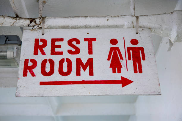 rustic stencil rest room sign on ship. passenger vessel comfort room facility. old rustic ship interior signage - daily cruiser imagens e fotografias de stock