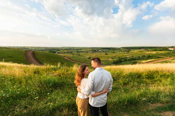 istock Young couple enjoying landscape outdoors, rear view 1264240777