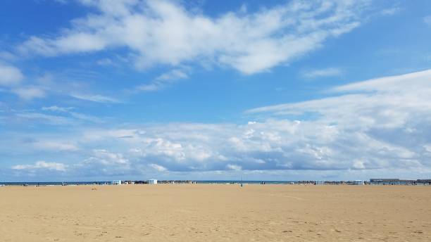 istock Sandy beach under a sunny blue sky with bright sun shinning in Valencia Spain 1264240844
