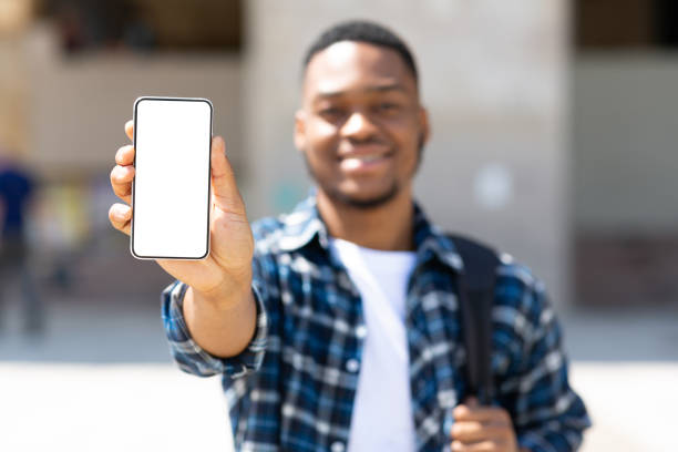 istock Afro man showing blank mobile phone screen 1264242642
