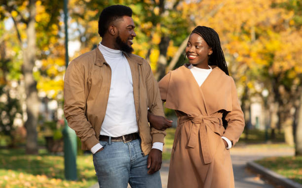 istock Happy young afro couple walking in autumn park 1264244473