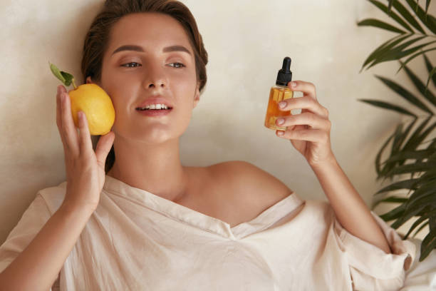 Skin Care. Beauty Portrait Of Woman Holding Lemon And Bottle Near Face. Natural Cosmetic Product For Hydrated Healthy Facial Derma. Essential Oil And Vitamin C For Anti-Aging Therapy. Skin Care. Beauty Portrait Of Woman Holding Lemon And Bottle Near Face. Natural Cosmetic Product For Hydrated Healthy Facial Derma. Essential Oil And Vitamin C For Anti-Aging Therapy. collagen photos stock pictures, royalty-free photos & images
