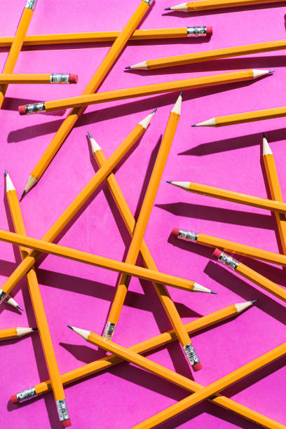 istock Pencils: pattern of orange pencils from above on pink background. Office and school concept 1264246778